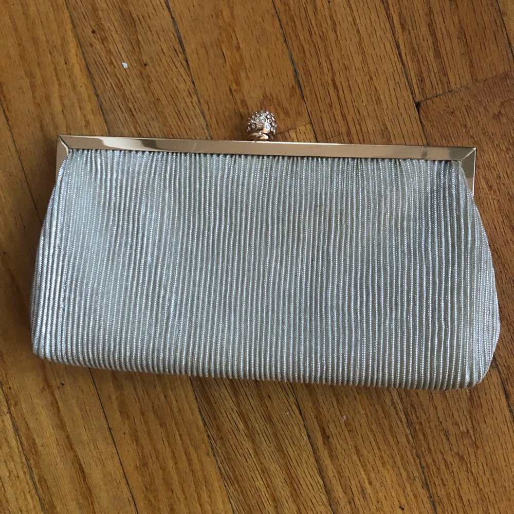 Pleated clutch with delicate drop-in chain strap.